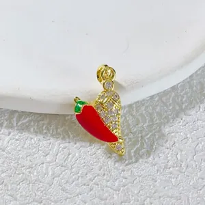 Detailed close-up view of the gold-plated rhinestone pavé and colorful enamel chili pendant.