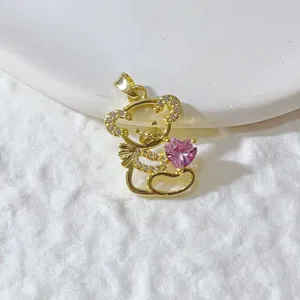 Close-up detail view of a gold-tone rhinestone squirrel pendant with a pink crystal heart charm.