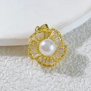 Gold plated copper pearl pendant necklace with sparkling baguette cubic zirconia stones.