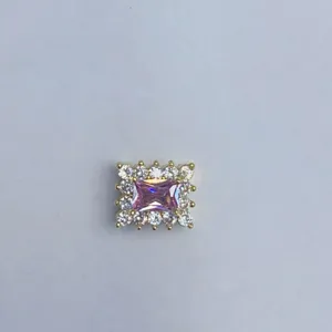 Primo piano di un ciondolo zircone rosa rettangolare con alone di pietra chiara per bigiotteria.