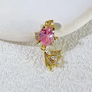 Goldfisch Anhänger Detail Nahaufnahme, rosa Kristallstein Besatz, zarte vergoldete Schmuck.