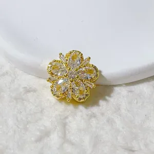 Close-up detail of 18K gold plated zircon flower spacer bead, perfect for DIY jewelry making.