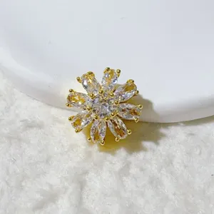Close-up detail of 18K gold plated zirconia flower spacer bead DIY jewelry accessory.
