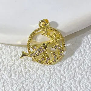 Nahaufnahme Detailaufnahme eines vergoldeten Delfin und Seestern Anhängers mit glitzernden Zirkonia.