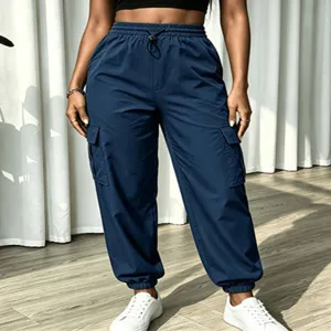 Close-up of casual solid color cargo pants detail, high waist and multi-pocket design.