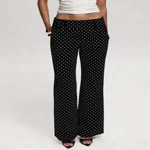 Detail view of black low-waist polka dot flare pants, featuring a vintage retro bell-bottom style.