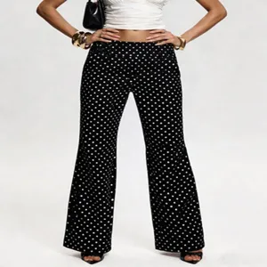 Detailed view of women's black and white polka dot low waist flare pants, vintage style.