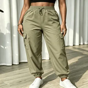 Detailed view of women high waist green cargo trousers with multiple pockets and drawstring.