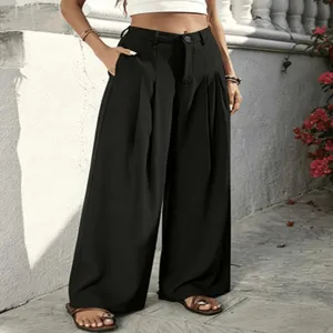 Outdoor detail shot of high-waisted black pleated wide-leg trousers showcasing drape and pocket.