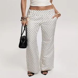 Black and white polka dot low-waist flare pants, stylish retro bell-bottom trousers.