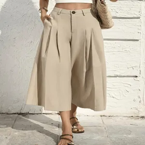 Detail shot of women high waisted cropped wide leg pants in beige, showing fabric drape and pleats.