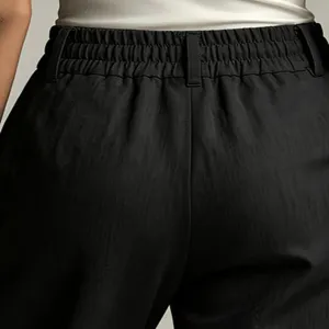 Waistband detail of women's high-waisted black casual trousers showing elastic and belt loops.