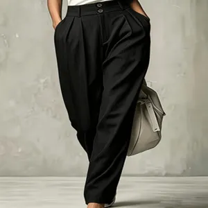 High-waisted pleated trousers for women, chic black carrot pants with loose fit and elegant drape.