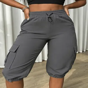 Grey cargo capris detail shot showing side pockets, elastic drawstring waist and cuffed hems.