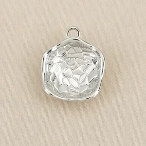 Detailed view of the irregular silver-colored metal pendant charm, perfect for DIY jewelry.