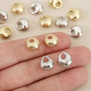 Close-up of gold and silver tone metal pouch beads diy jewelry charms accessories details.