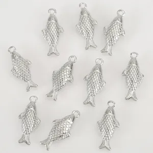 Detailed view of silver tone metallic 3d fish charms with textured scales and top loop for diy.