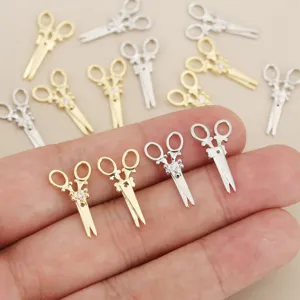 Close-up detail of mini scissor charms with sparkling zirconia, gold and silver DIY parts.