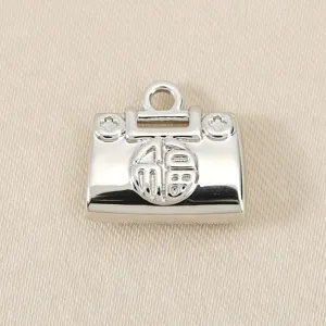 Gros plan détaillé du mini pendentif cadenas sac à main argenté avec symbole de chance.