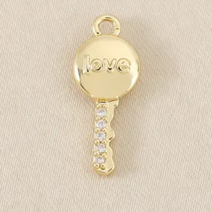 Gold plated key pendant diy jewelry accessory with love engraving and sparkling rhinestones.