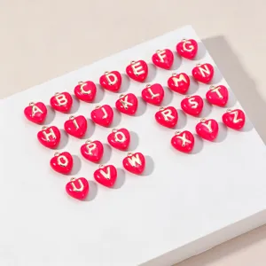 Pink enamel heart alphabet pendants A to Z gold raised letter charms for DIY jewelry making.