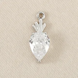 Detailed shot of a silver-toned carrot pendant featuring a sparkling clear cubic zirconia stone.