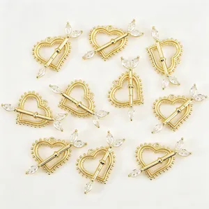 Detailed shot of gold-plated heart arrow pendants with clear cubic zirconia DIY jewelry parts.