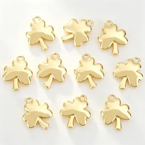 Detailed view of shiny gold plated three-leaf clover charms, perfect for DIY jewelry making.