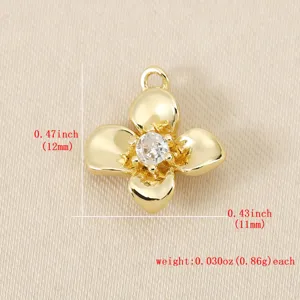 Close-up detail of 18k gold plated brass four-petal flower pendant with sparkling cubic zirconia.