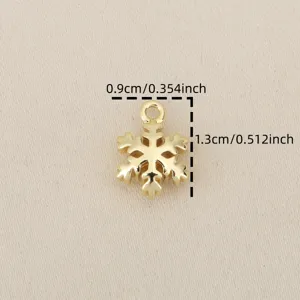 Gold snowflake pendant detail close up view, diy jewelry accessory, small cute charm.