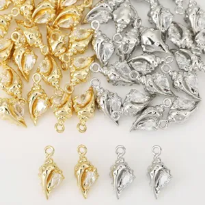 Close-up detail of exquisite shell charms with cubic zirconia, featuring gold and silver finishes.