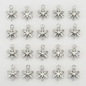 Snowflake pendant jewelry accessory detail, silver tone metal craft charm for DIY making.