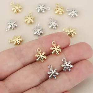 Small snowflake metal charms in gold and silver, perfect for DIY jewelry making crafts.