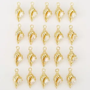 Close-up of gold-plated conch pendant details, sparkling zirconia inlay, DIY jewelry parts.