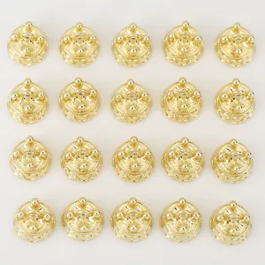 Close-up of gold-plated crown charm pendants, vintage DIY jewelry making accessories.