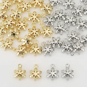 Detailed view of shiny gold and silver snowflake metal charms for DIY jewelry making.