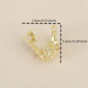 Close-up detail of 18k gold plated bow flower pendant, sparkling zircon inlay DIY jewelry charm.