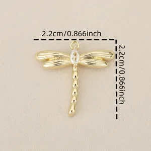 Close-up detail of a gold plated dragonfly pendant with sparkling cubic zirconia stone.
