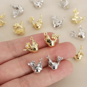 Detailed shot of gold and silver zircon bow flower DIY pendants, showing exquisite craftsmanship.
