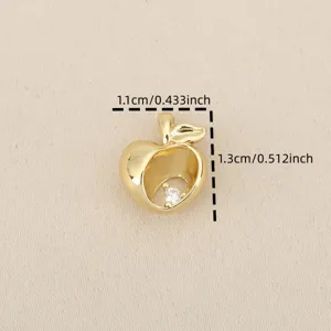 Close-up of 18k gold plated copper hollow apple pendant with sparkling zircon detail.