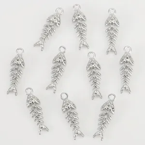 Close-up detail of silver fish bone charms, perfect for DIY jewelry making and craft projects.