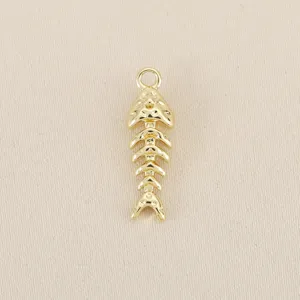 Close-up view of the shiny gold-plated fish bone pendant DIY jewelry accessory.