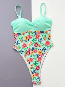 Detailed view of mint green one-piece swimsuit with vibrant floral print bottom and straps.