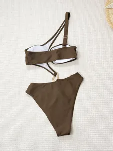 Solid brown one-shoulder asymmetric monokini swimsuit with metal ring detail flat lay view.
