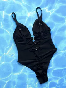 Black one-piece swimsuit with metal rings, lace-up details, and ruching for women swimwear detail