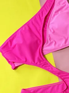 Detailed view of the vibrant pink color-block bikini bottom, featuring sexy design for summer.