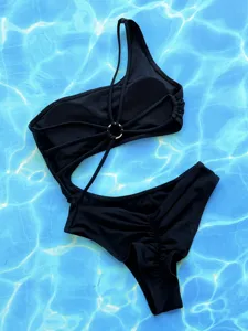 Black one-piece cutout monokini swimsuit featuring stylish metal ring and multi-strap details.