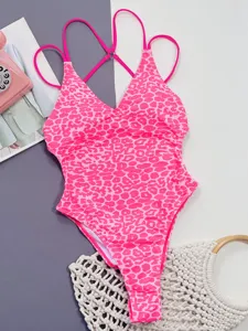 Pink leopard print one-piece swimsuit with V-neck and crisscross straps for women.