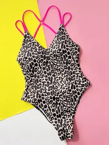 Detailed view of sexy one-piece leopard print swimsuit with bright pink double straps.