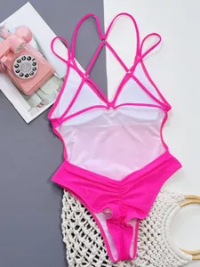 Hot pink one-piece swimsuit with cross straps and ruched detail for women stylish beachwear